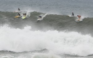 Dropping in on the wave Surfers on 20 foot wave at the North Shore.