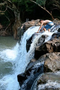 Waterfall jump Michael maneuvering around the slippery rocks at the top of the waterfall